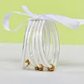 Elegant set of 5 white silicone glitter bangles with gold lotus charms and ribbon - 5 Pieces / White