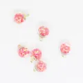 Macro detail of 16mm round glass ball pendants filled with pink star-shaped sequins. - Rose Red