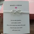 Infinity symbol wish bracelet with white cord and 'Make a Wish' card message - Infinity Symbol (EB0168) / White