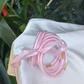 Set of 9 stylish pink glitter jelly bangles with golden spacers tied with a silk ribbon - 9 Pieces Set / Light Pink