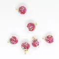 Close-up detail of 16mm glass sphere charms with colorful pink star-shaped sequins inside - Red