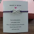 Close-up detail showing the silver infinity symbol charm on a purple braided cord - Infinity Symbol (EB0168) / Purple