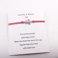 Handmade red cord wish bracelet with vintage silver turtle charm on a white display card - Red