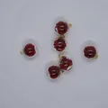 Close-up of 16mm transparent glass ball charms with red glitter for DIY jewelry making - Red