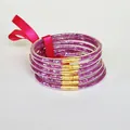 Detailed macro view of 6-piece pink glitter silicone bangles set with a silk ribbon bow - Rose Red