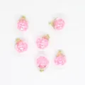 Macro detail of 16mm transparent glass ball charms filled with shimmering pink star sequins - Pink