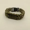 Close-up of paracord bracelet with American flag metal plate and black buckle - Camouflage
