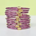 Set di 10 braccialetti in silicone glitterati viola con fermagli a forma di loto dorati - Confezione da 10 / Magenta
