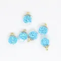 Macro detailed view of 16mm clear glass ball charms filled with tiny light blue stars - Light Blue