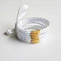 Set of 6 white glitter filled silicone bangles with a decorative white satin ribbon bow - White