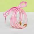Set of 5 pink glitter silicone bangles with matching ribbon and gold lotus charms - 5 Pieces / Pink