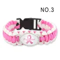 Detail of pink and white paracord bracelet with Fighter ribbon emblem - Fighter / Pink & White Woven