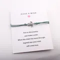 Bracelet en cordon turquoise avec breloque tortue argentée sur carte Make a Wish - Vert Foncé