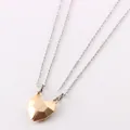 Close-up detail of magnetic geometric heart-shaped pendants for couple necklace sets - Gold