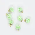 Detailed view of 16mm round transparent charms filled with light green foam balls for DIY. - Army Green