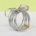 Set of 5 silver glitter silicone bangles with grey ribbon tie and gold lotus clasp - 5 Pieces / Silver