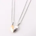 Detail of two magnetic heart necklaces in gold and silver, attracting together. - White Gold Plated Pendant