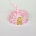Set of 6 pink glitter silicone bangles with decorative bow ribbon and gold beads - Pink