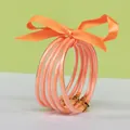 Five piece set of orange glitter silicone bangles tied with matching orange satin ribbon - 5 Pieces / Orange