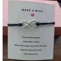 Infinity symbol charm bracelet on a Make a Wish card with a dark navy cord. - Infinity Symbol (EB0168) / Navy Blue