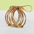Elegant set of five golden glitter-filled silicone bangles tied with a brown silk ribbon - 5 Pieces / Antique Gold