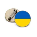 Close-up detail of a vintage bronze Ukraine flag brooch showing both front and back sides - Ukrainian Coat of Arms