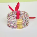 Set of 6 colorful glitter-filled PVC bangles tied with a pink decorative ribbon bow - Colorful