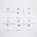 Set of six colorful wax cord wish bracelets with silver-colored angel tooth charms. - Multicolor