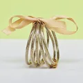Set of 5 glitter-filled silicone bangles with ribbon and gold metal charms - 5 Pieces / Light gold