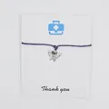 Detailed view of angel tooth charm bracelet on card with Thank you message printed - Purple