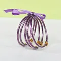 Set of 5 purple glitter silicone bangles with matching ribbon and gold lotus buckle. - 5 Pieces / Mixed Purple