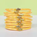 Set de 9 bracelets en silicone pailleté orange avec d'élégants charms lotus dorés - Pack de 9 Pièces / Moutarde