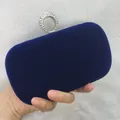 Close-up detail of a luxurious royal blue velvet clutch bag with a sparkly rhinestone ring clasp - S / Blue