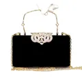 Elegant black velvet evening clutch bag with rhinestone crown clasp and gold chain strap. - Black