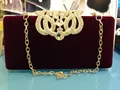 Elegant burgundy velvet evening clutch bag with rhinestone crown ornament and gold chain. - Burgundy