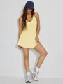 Full-length view of a yellow backless tennis dress worn by a model in a studio - S / Dresses / Yellow
