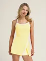 Close-up detail of a vibrant yellow halter neck tennis dress with white contrast trim - S / Top And Bottom / Yellow