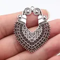Large vintage silver-toned ethnic pendant with intricate bohemian scrollwork detail - Antique Silver