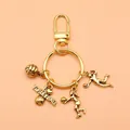 Creative gold volleyball themed keychain with heart pendant and athlete charms in SKU view - Antique Gold (XY30007)