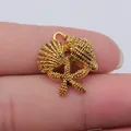 Antique gold vintage ocean theme pendant featuring a shell, conch and starfish design - Antique Gold