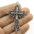 Ornate vintage silver cross pendant held in hand for DIY jewelry making accessories - Antique Silver