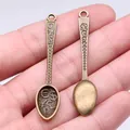 Vintage bronze zinc alloy spoon pendant with currency symbols, showing front and back - Wealthy Spoon (A13450) / Antique Bronze