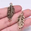 Bronzen vintage veerverbinder bedeltjes voor handgemaakte DIY sieraden 35x14mm maat - Veervorm (A13424) / Antiek Brons