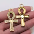 Pair of gold-colored Egyptian Ankh cross pendants with intricate Celtic knot patterns - Ankh Cross (D10374) / Antique Gold