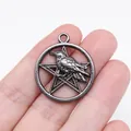 Vintage gothic metallic raven pendant with pentagram design, held between fingers for scale - Punk Pentagram Raven (D11658)