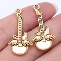 Set of two gold winged guitar charms for jewelry making, 31x10mm zinc alloy pendants - Antique Gold (D10621)