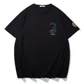 Stylish black oversized fashion printed T-shirt featuring reflective and gold foil graphics - XL / Tops / Black