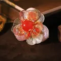 Elegant baroque pearl brooch featuring a red gemstone flower and golden filigree petal design - Red Natural Stone Flower / Red