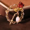 Elegant rose brooch with red petals and natural pearl drop in gold-tone finish - Red Rose (GO0005)