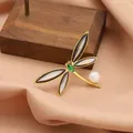 Elegant golden dragonfly brooch featuring green crystal and freshwater pearl detail - Black Dragonfly Pearl Style
